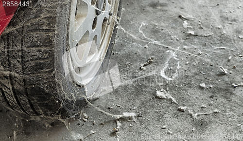 Image of 80’s tire among cobwebs