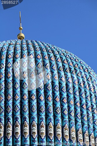 Image of Tiled dome of a mosque with a golden crescent 