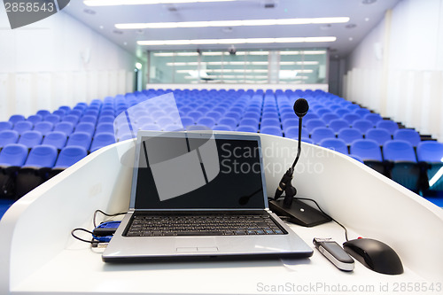 Image of Laptop on the rostrum in conference hall.
