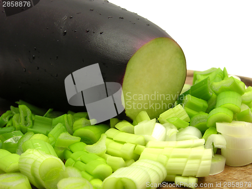 Image of Eggplant and cutted  spring onion on wooden plate 