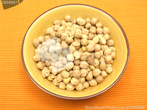 Image of One bowl of ceramic with garbanzos on orange