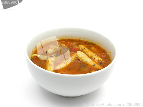 Image of Noodle soup with tomatoes and herbs on white