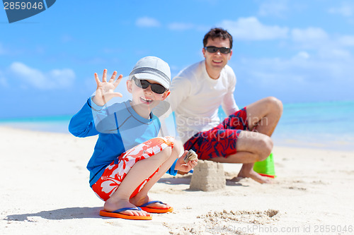 Image of family building sand castle