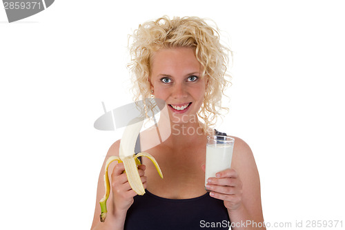 Image of Young woman with milk and bana