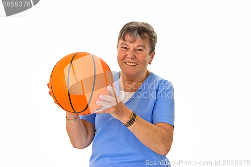 Image of Senior woman playing basketball