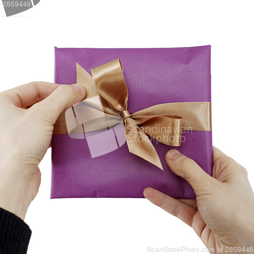 Image of Young woman holding a present