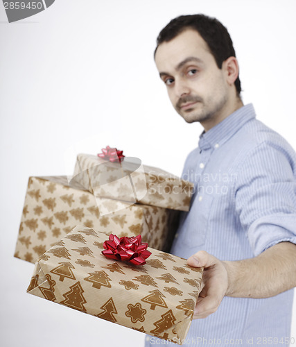 Image of Young man holding a present