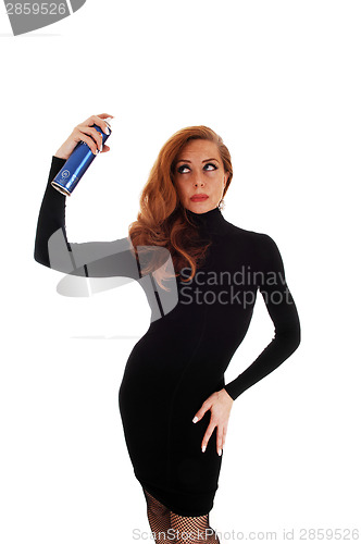 Image of woman using hair spray.