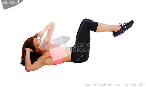 Image of Woman doing stomach crunch.
