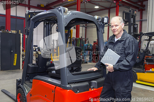 Image of Forklift mechanic with manual