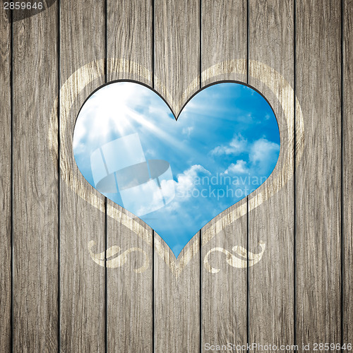 Image of wooden heart with the blue sky