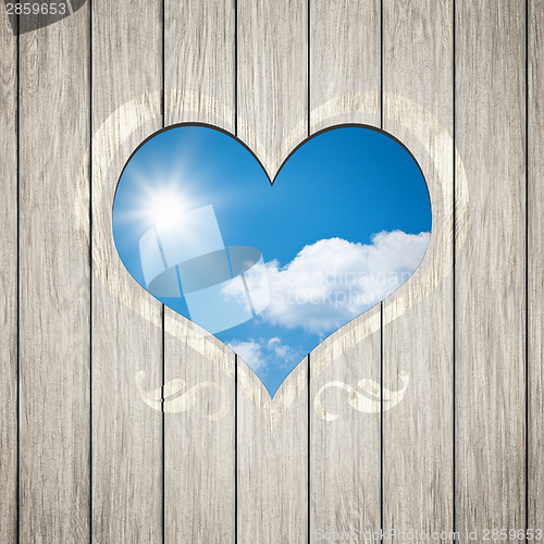 Image of wooden heart with the blue sky