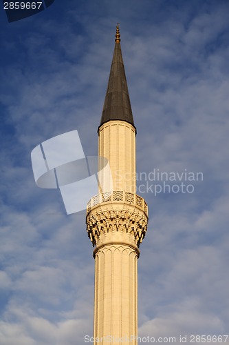 Image of Minaret of mosque against sky with clouds