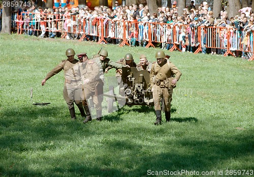 Image of Soldiers wheel artillery cannon