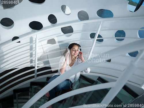 Image of relaxed young woman at home working on laptop