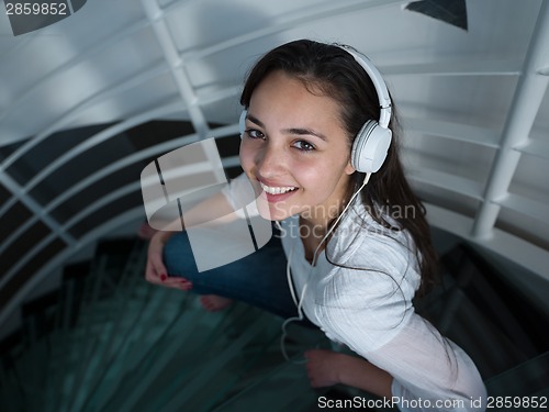 Image of relaxed young woman at home working on laptop