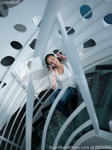 Image of relaxed young woman at home working on laptop