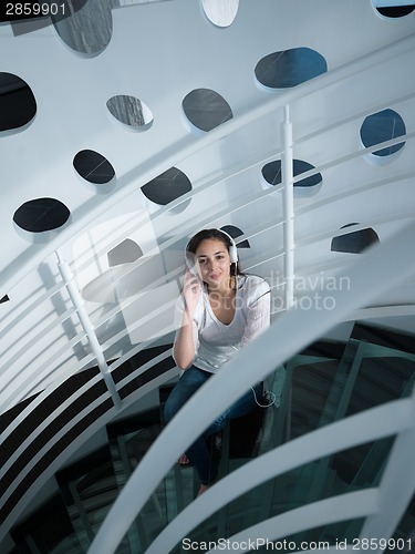 Image of relaxed young woman at home working on laptop