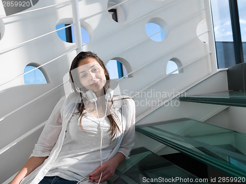 Image of relaxed young woman at home working on laptop
