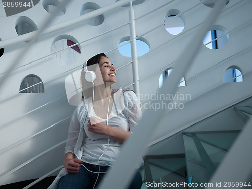 Image of relaxed young woman at home working on laptop