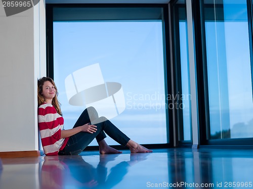 Image of relaxed young woman at home working on laptop