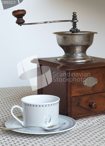 Image of Coffee grinder and cup of coffee