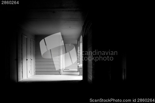 Image of dark corridor leading to outside light