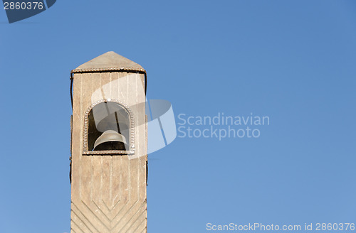 Image of wooden belfry toy model on blue sky background 