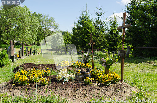 Image of freshly made grave soil and foundation in cemetery 