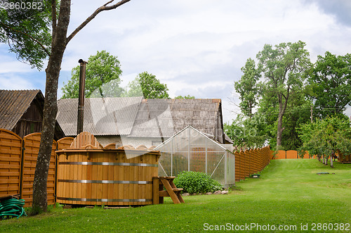 Image of rural wooden fence separates the two courtyards  