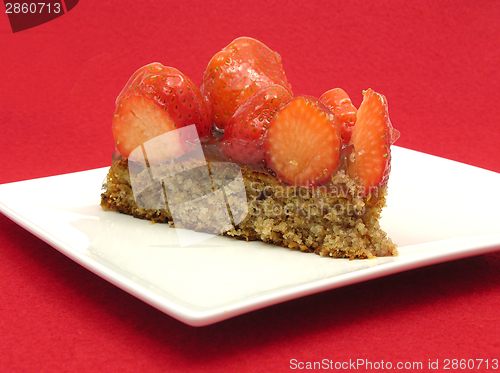 Image of One slice of strawberry cake on white plate on red background