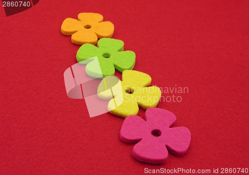 Image of Flowers of felt  on a red felt