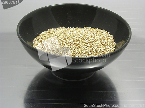 Image of Bowl of chinaware with quinoa on reflecting matting