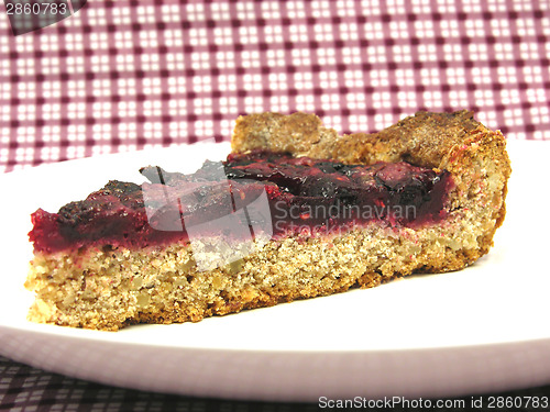 Image of One piece of berry cake on a white plate