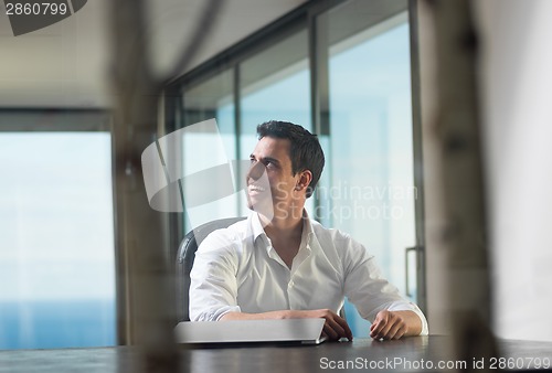 Image of business man working on laptop computer at home