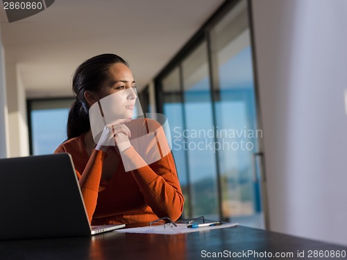 Image of woman working on laptop computer at  home