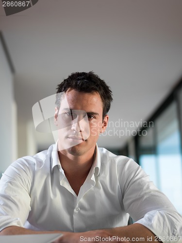 Image of business man working on laptop computer at home