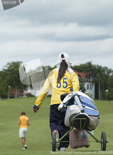 Image of Golf caddie and player