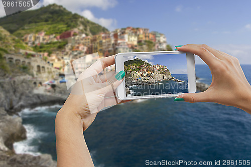 Image of Manorola photographing with mobile phone
