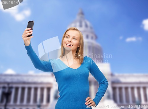 Image of woman taking self picture with smartphone camera