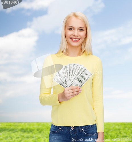 Image of smiling girl with dollar cash money