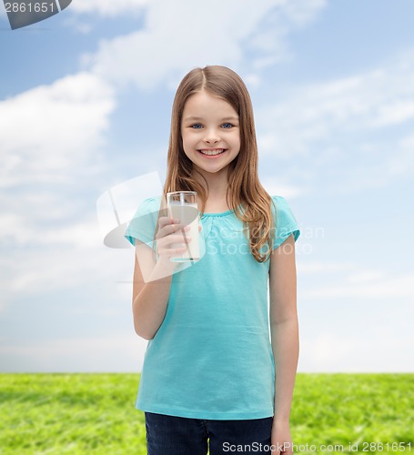 Image of smiling little girl with glass of milk