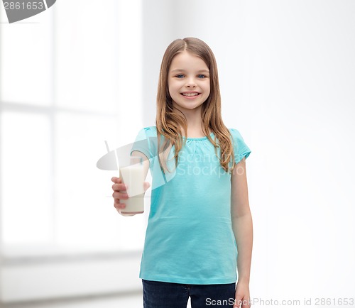 Image of smiling little girl giving glass of milk