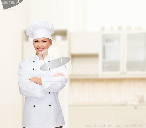 Image of smiling female chef with crossed arms