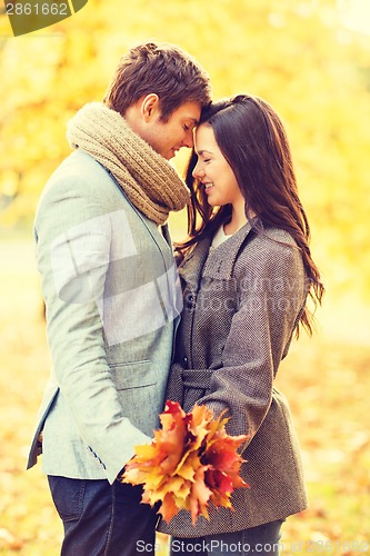 Image of romantic couple kissing in the autumn park