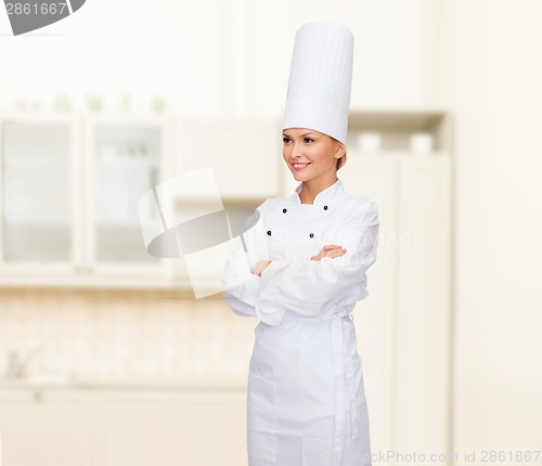Image of smiling female chef with crossed arms
