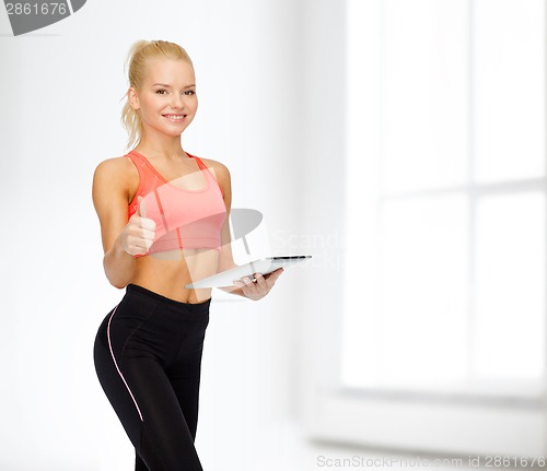 Image of smiling sporty woman with tablet pc computer