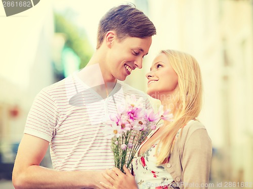 Image of couple with flowers in the city