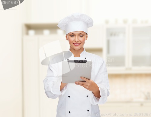 Image of smiling female chef with tablet pc computer