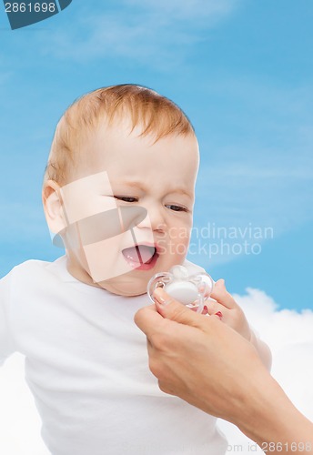 Image of crying baby with dummy